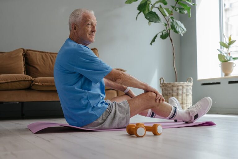 Elderly man exercising at home with yoga and weights for a healthy lifestyle.